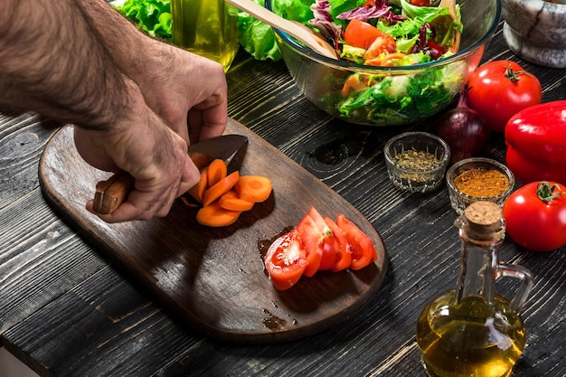 chef preparing vegetables on wooden table